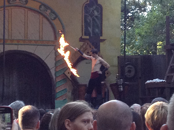 An actor uses fire effects to make his whip show more spectacular